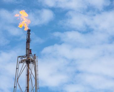 Methane Gas Fire High Flare Stack Flaring Tower Platform in Refinery Petroleum Plant or Flame Burn On Offshore Oil Extraction Process.